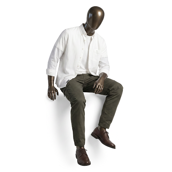 Seated model wearing a white shirt and olive trousers